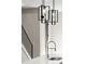 A modern kitchen light fixture hangs above a stainless steel faucet at 2333 Mason Dr # D26, Atlanta, GA 30316