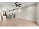 Open-concept living room boasts modern light fixtures, stainless steel appliances, and hardwood floors at 2333 Mason Dr # D26, Atlanta, GA 30316