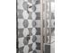 Close-up of shower featuring geometric tile and glass door at 2333 Mason Dr # D26, Atlanta, GA 30316