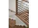 Close up of staircase featuring hardwood steps and a modern black metal and wood railing at 2333 Mason Dr # D26, Atlanta, GA 30316