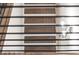 View of staircase with wood steps and black metal railing through horizontal blinds at 2333 Mason Dr # D26, Atlanta, GA 30316
