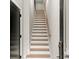 Bright staircase featuring wood treads, white risers, light walls, and a wood handrail at 2333 Mason Dr # D26, Atlanta, GA 30316