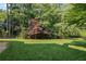The lush backyard offers a large lawn and mature trees at 310 Ivy Brooke Ct, Atlanta, GA 30342