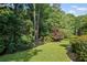 A beautifully landscaped yard with mature trees creates a private outdoor space at 310 Ivy Brooke Ct, Atlanta, GA 30342
