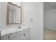 A clean half bath offers a white vanity, sink and mirror with modern fixtures at 310 Ivy Brooke Ct, Atlanta, GA 30342