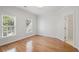 Bright bedroom features hardwood floors, two windows, and white trim at 310 Ivy Brooke Ct, Atlanta, GA 30342