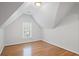 Bedroom features light gray walls, hardwood floors, and one window at 310 Ivy Brooke Ct, Atlanta, GA 30342