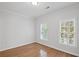 Clean bedroom with hardwood flooring and two windows at 310 Ivy Brooke Ct, Atlanta, GA 30342
