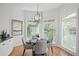 Charming breakfast nook with a modern chandelier and lots of natural light from the surrounding windows at 310 Ivy Brooke Ct, Atlanta, GA 30342