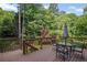 View of a deck with dark wood and seating area with an umbrella table at 310 Ivy Brooke Ct, Atlanta, GA 30342