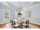 Bright dining room with a modern chandelier, light blue walls, and plenty of natural light at 310 Ivy Brooke Ct, Atlanta, GA 30342