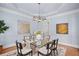 Stylish dining room featuring a glass table, modern light fixture, and chic decor at 310 Ivy Brooke Ct, Atlanta, GA 30342