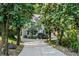 A long driveway leads to a stately home nestled among mature trees at 310 Ivy Brooke Ct, Atlanta, GA 30342