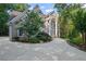 A stately home boasts elegant architectural details and lush landscaping at 310 Ivy Brooke Ct, Atlanta, GA 30342