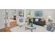 Bright living room with hardwood floors, built-in shelving, fireplace, and comfortable seating arrangement at 310 Ivy Brooke Ct, Atlanta, GA 30342