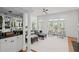 Spacious living room with bar area, multiple seating options, and large windows offering natural light at 310 Ivy Brooke Ct, Atlanta, GA 30342