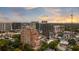 Beautiful aerial view showcasing a luxury condo, lush greenery, and the city skyline at sunset at 3180 Mathieson Ne Dr # 1401, Atlanta, GA 30305
