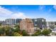 Picturesque aerial view showcasing a luxury condo building surrounded by trees and high-rise buildings at 3180 Mathieson Ne Dr # 1401, Atlanta, GA 30305