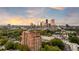Majestic aerial view of a luxury condo, with the stunning city skyline as a backdrop at sunset at 3180 Mathieson Ne Dr # 1401, Atlanta, GA 30305