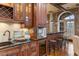 Wet bar featuring wooden cabinets, bar stool seating, and a wine fridge at 3180 Mathieson Ne Dr # 1401, Atlanta, GA 30305