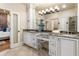Elegant bathroom with double vanities, granite countertops and view to the adjacent bedroom at 3180 Mathieson Ne Dr # 1401, Atlanta, GA 30305