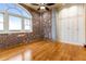 Bedroom with exposed brick walls, hardwood floors, and modern finishes, and window with a view at 3180 Mathieson Ne Dr # 1401, Atlanta, GA 30305