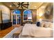 Cozy bedroom featuring exposed brick, arched windows, and a decorative sunburst mirror at 3180 Mathieson Ne Dr # 1401, Atlanta, GA 30305