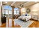 Spacious bedroom with exposed brick, arched windows, and natural light. Includes a decorative mirror at 3180 Mathieson Ne Dr # 1401, Atlanta, GA 30305