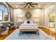 Bedroom with exposed brick, arched windows, and hardwood floors with views to ensuite bathroom at 3180 Mathieson Ne Dr # 1401, Atlanta, GA 30305