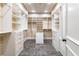 Large walk-in closet featuring custom shelving and drawers and tile floors at 3180 Mathieson Ne Dr # 1401, Atlanta, GA 30305