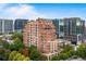 Stunning brick condo building featuring many windows and balconies in a vibrant city setting at 3180 Mathieson Ne Dr # 1401, Atlanta, GA 30305