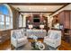 Bright living room featuring exposed brick, arched windows, hardwood floors and a fireplace at 3180 Mathieson Ne Dr # 1401, Atlanta, GA 30305