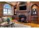 Living room with custom entertainment center, fireplace, and natural light at 3180 Mathieson Ne Dr # 1401, Atlanta, GA 30305