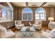 Bright living room featuring exposed brick, arched windows, and hardwood floors at 3180 Mathieson Ne Dr # 1401, Atlanta, GA 30305