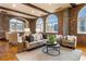 Bright and airy living room featuring exposed brick and comfortable seating at 3180 Mathieson Ne Dr # 1401, Atlanta, GA 30305