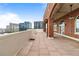 Gorgeous penthouse patio featuring brick columns, tile flooring, and stunning city views at 3180 Mathieson Ne Dr # 1401, Atlanta, GA 30305