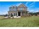 Charming two-story home featuring a mix of brick and blue siding, complemented by a well-manicured lawn at 352 Foxglove Way, Mcdonough, GA 30253