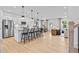 Open-concept kitchen with white cabinets, stainless steel appliances, and an island with bar seating at 352 Foxglove Way, Mcdonough, GA 30253