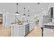 Bright kitchen with white cabinets, stainless steel appliances, and a large central island at 352 Foxglove Way, Mcdonough, GA 30253