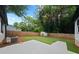 Backyard features a well-maintained lawn, privacy fence, and concrete patio, perfect for outdoor entertaining at 4946 Lake Ridge Trail, Lilburn, GA 30047