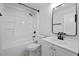 Clean white bathroom featuring a shower-tub combo with a single sink vanity and modern fixtures at 4946 Lake Ridge Trail, Lilburn, GA 30047