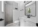 Modern bathroom featuring a glass-enclosed shower, sleek fixtures, and a vanity with a stylish mirror at 4946 Lake Ridge Trail, Lilburn, GA 30047