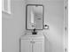 Modern bathroom boasts a bright vanity with black fixtures, an updated mirror, and a glass shower at 4946 Lake Ridge Trail, Lilburn, GA 30047