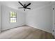 Bedroom with a large window for natural light and neutral colored walls and flooring at 4946 Lake Ridge Trail, Lilburn, GA 30047