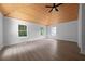 This large bedroom with light gray walls has wood-look floors and a vaulted ceiling with a modern ceiling fan at 4946 Lake Ridge Trail, Lilburn, GA 30047