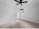 An installed ceiling fan and a large window accentuates this neutral bedroom at 4946 Lake Ridge Trail, Lilburn, GA 30047
