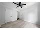 An airy bedroom featuring fresh gray paint, modern ceiling fan, and gray wood-look flooring at 4946 Lake Ridge Trail, Lilburn, GA 30047