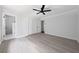 Spacious bedroom with en suite bathroom features attractive gray wood-look flooring and a ceiling fan at 4946 Lake Ridge Trail, Lilburn, GA 30047