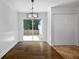Bright dining area with hardwood floors and sliding glass doors leading to the backyard at 4946 Lake Ridge Trail, Lilburn, GA 30047