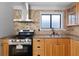 Well-lit kitchen boasts stainless steel appliances, double basin sink and attractive cabinetry at 4946 Lake Ridge Trail, Lilburn, GA 30047